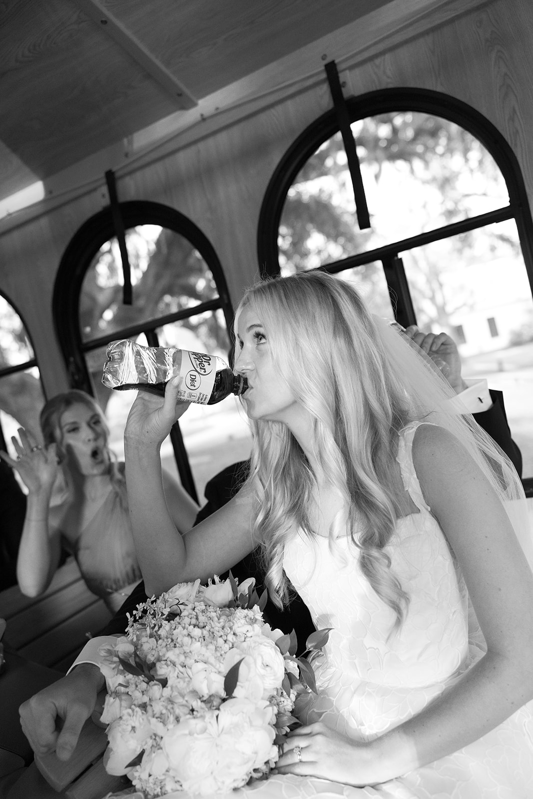 bride drinks a diet dr pepper on the trolley ride to Boone Hall Plantation Wedding
