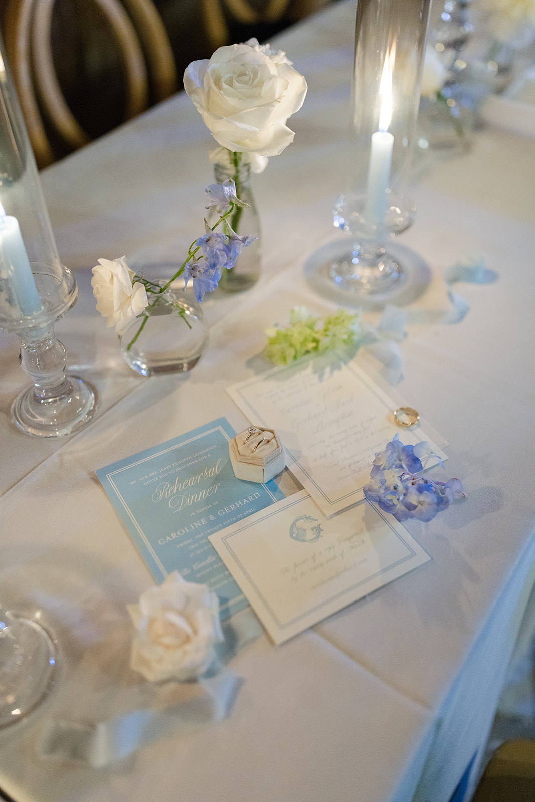 Flat lay of Caroline and Gerhard’s Charleston wedding stationery featuring light blue and white tones at Boone Hall Plantation.