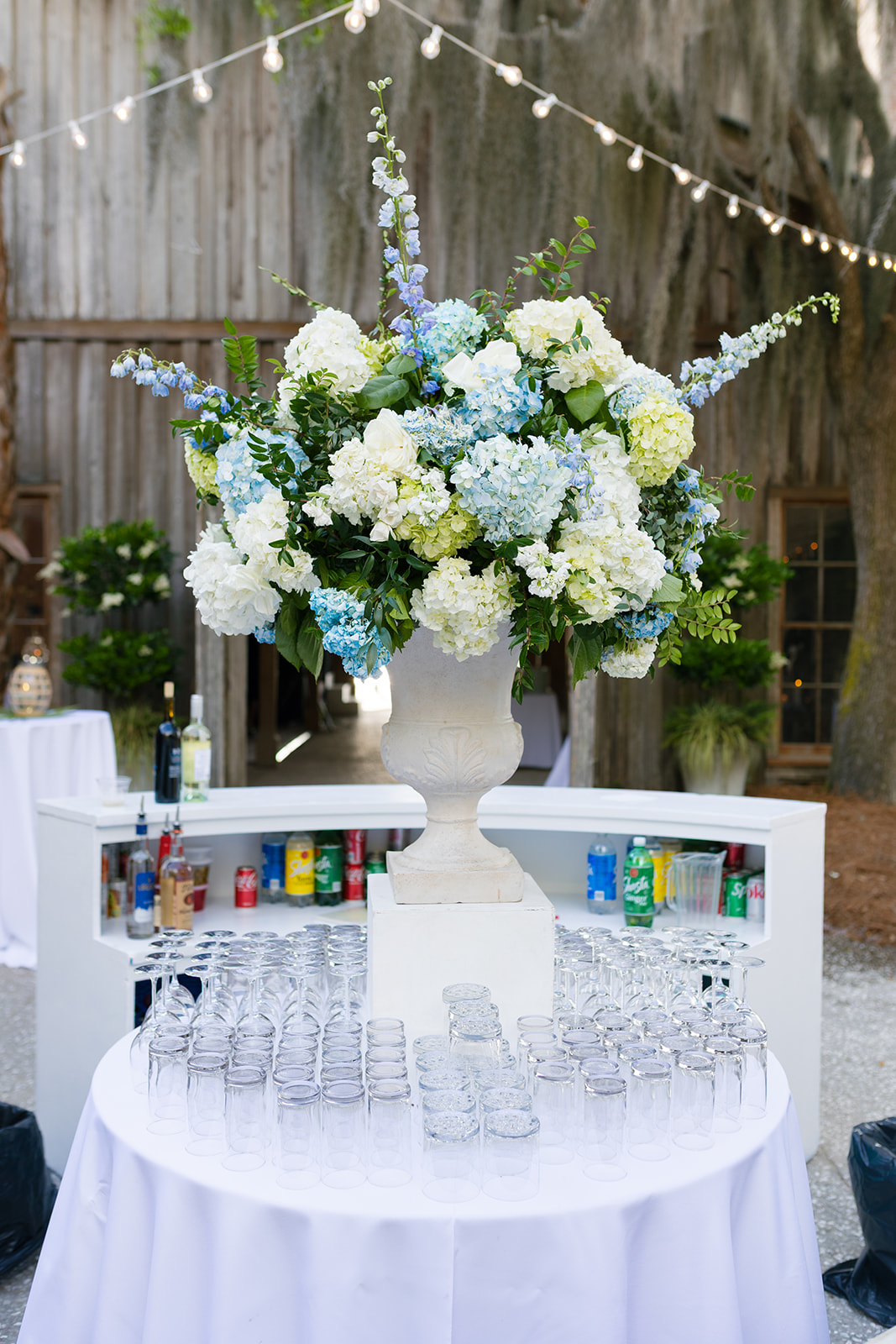 vibrant blue and white hydrangea centerpiece on the cocktail hour bar setup at Boone Hall Plantation during a Charleston wedding celebration.