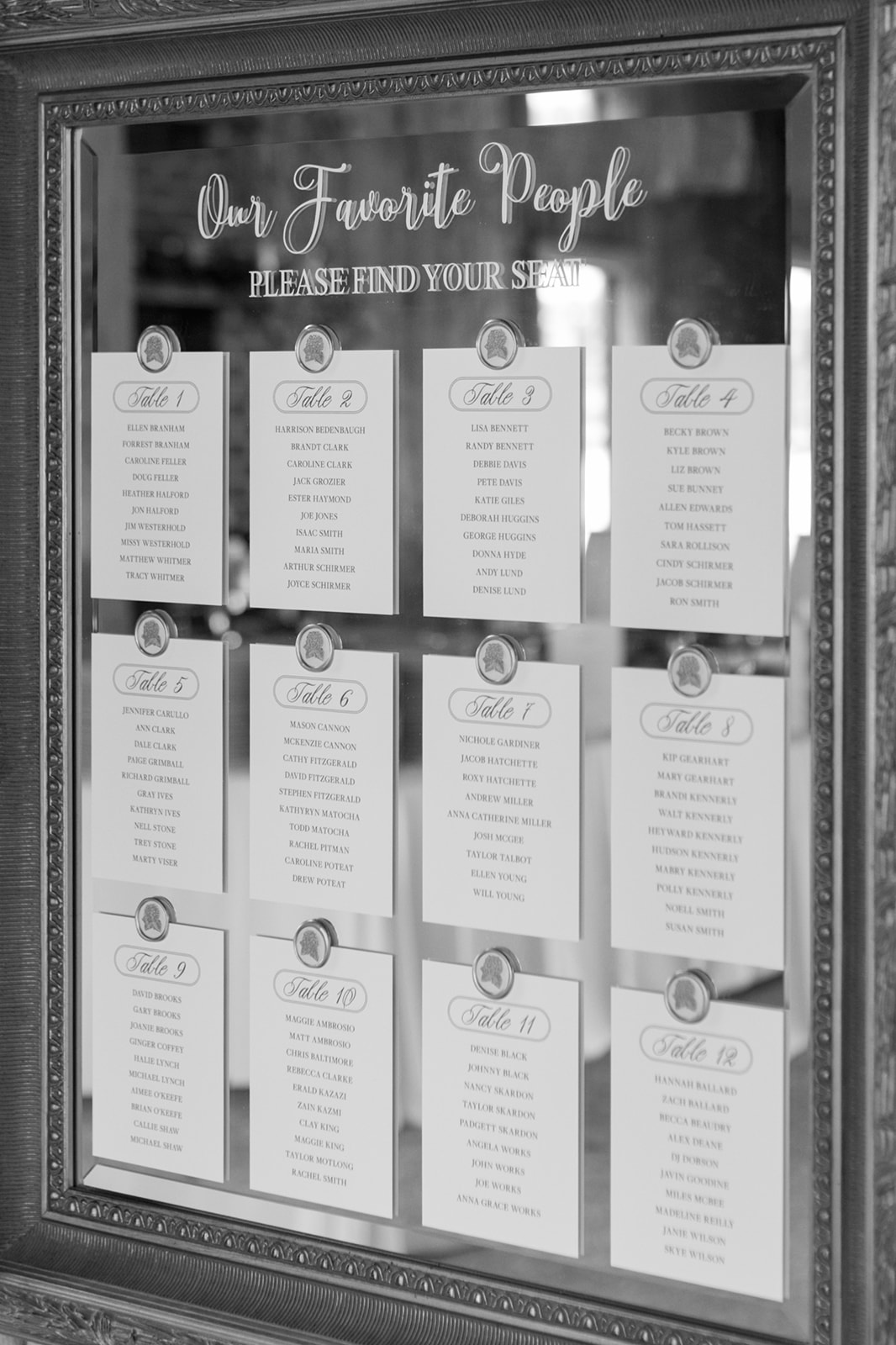 elegant wedding seating chart displayed on a vintage mirror at a Boone Hall Plantation wedding in Charleston.
