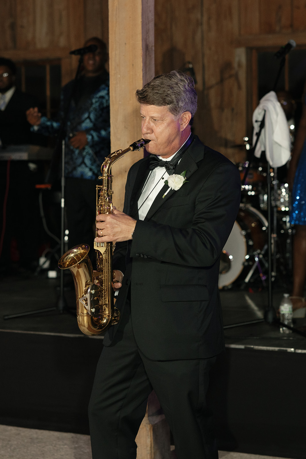 The father of the bride plays the saxophone 