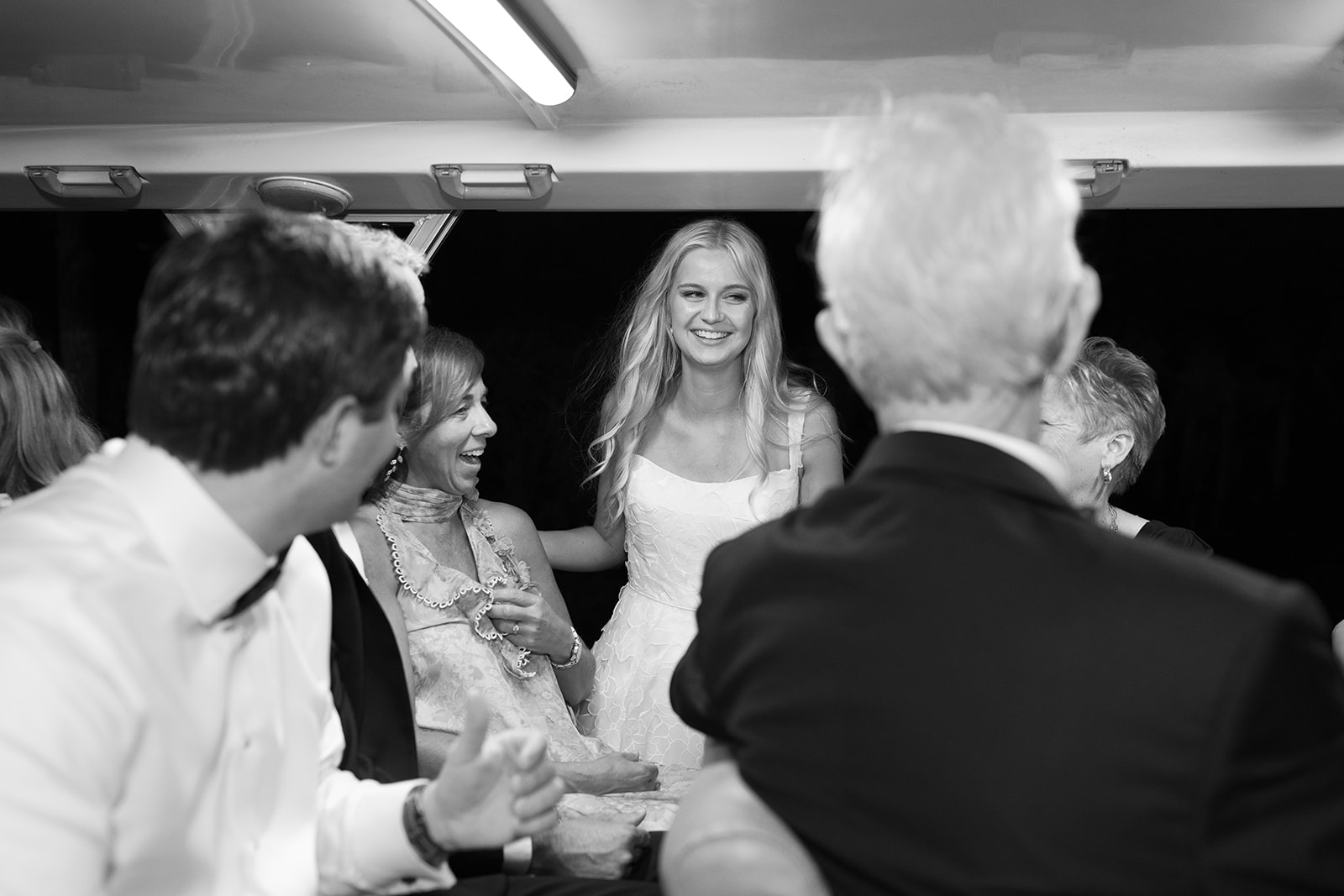 bride talks with guests on the shuttle