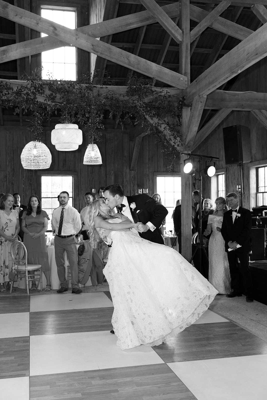 Groom kisses his bride as they dance