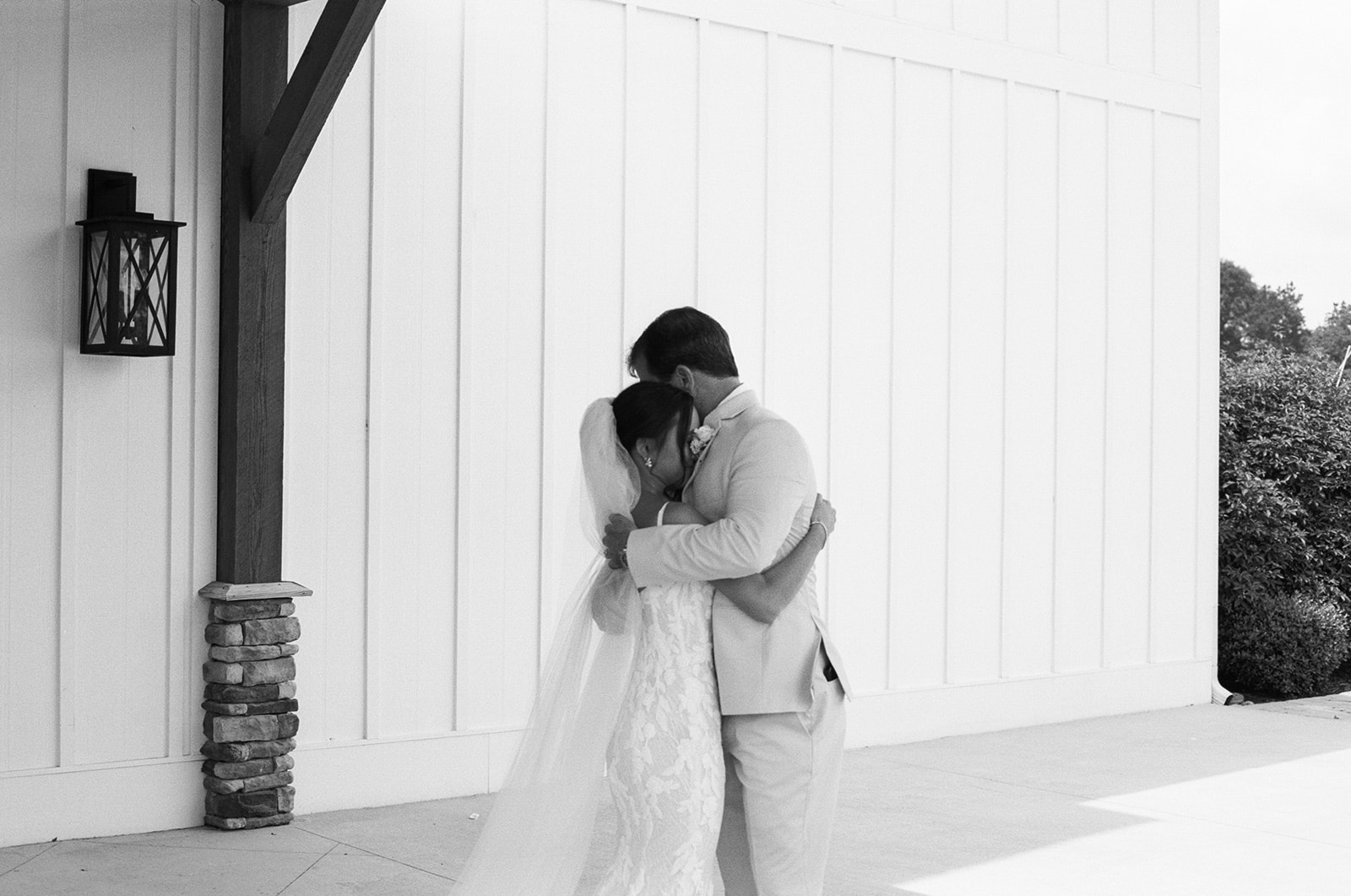 film photo of bride hugging her father outside The Venue at Edgewood during their first look