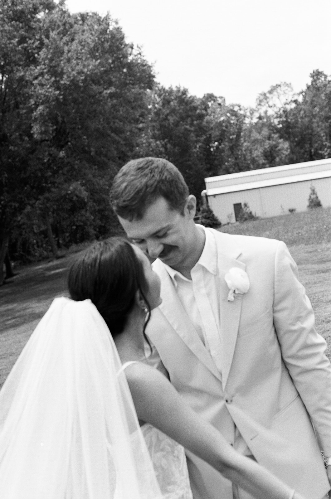 film photo of bride and groom outside The Venue at Edgewood