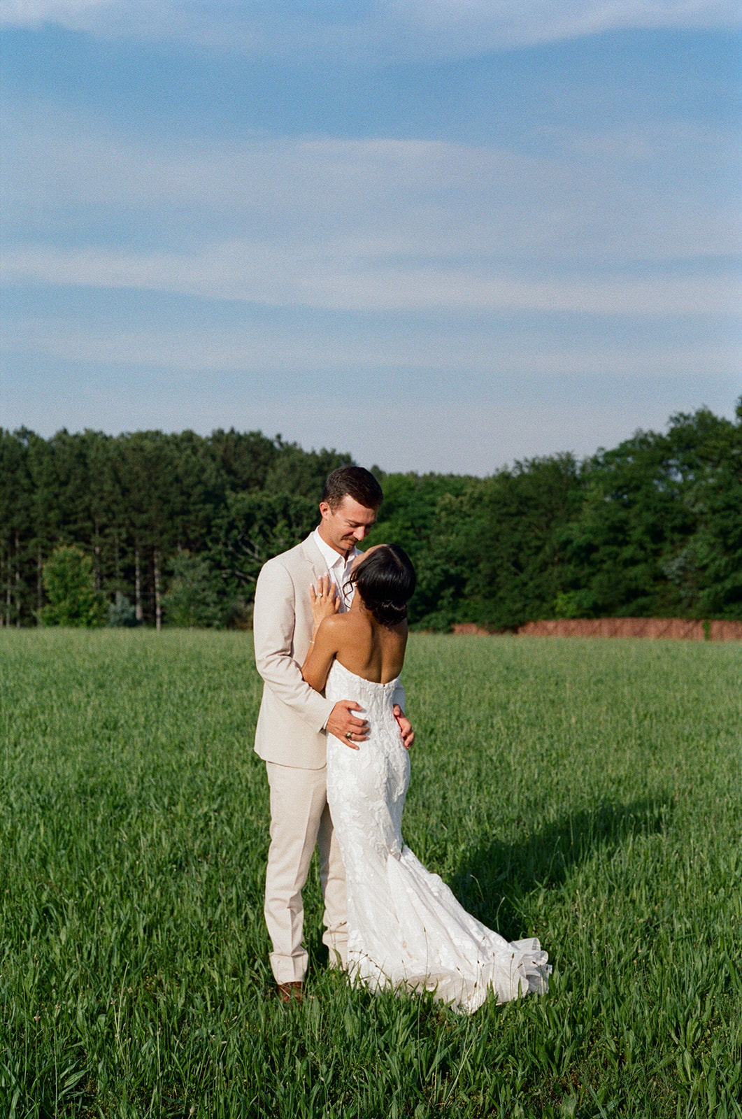 film photo of bride and groom share a loving glance during their sunset wedding photoshoot