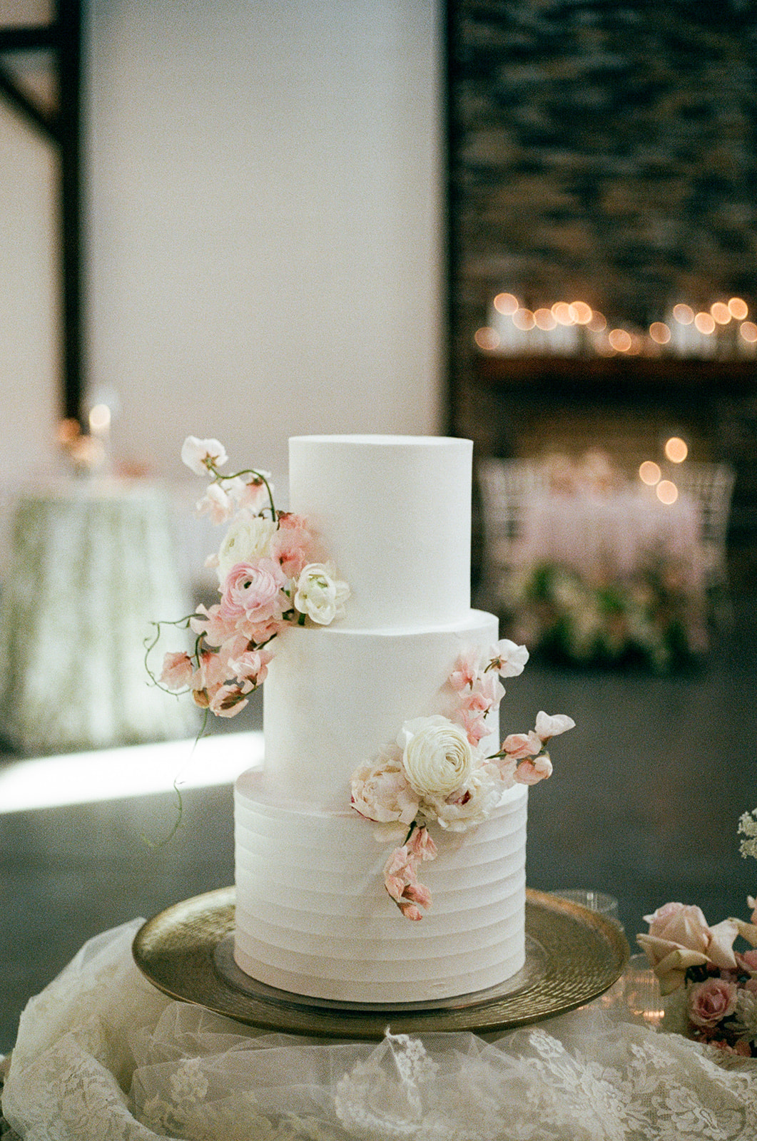 Film photo of a tiered wedding cake with florals
