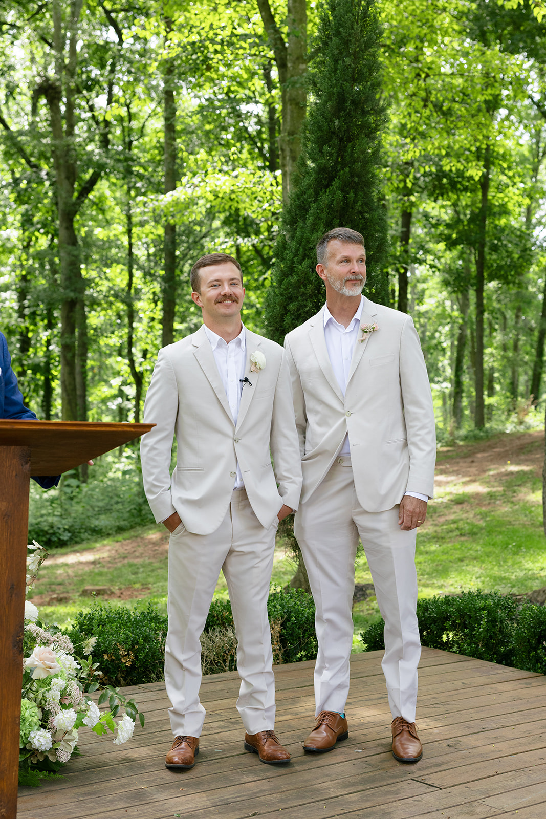 groom lovingly watches his bride walk down the aisle