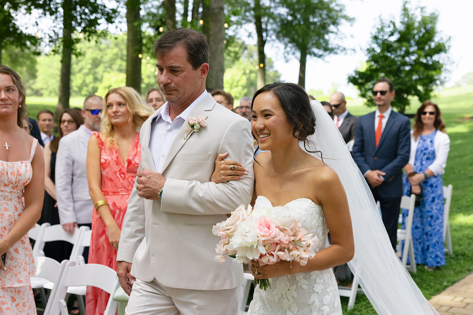 bride smiles at her groom as she walks down the aisle