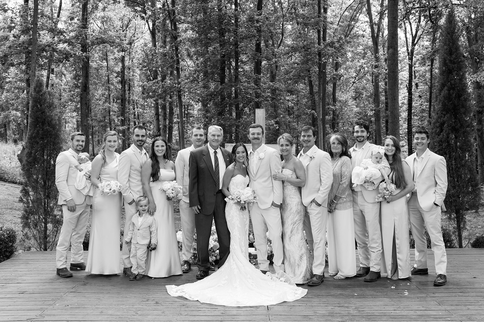 wide shot of the families of the newlyweds smiling with the bride and groom after their ceremony