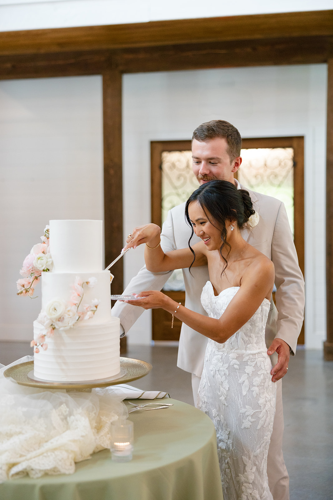 Bride and groom cut into their wedding cake at their South Carolina wedding reception