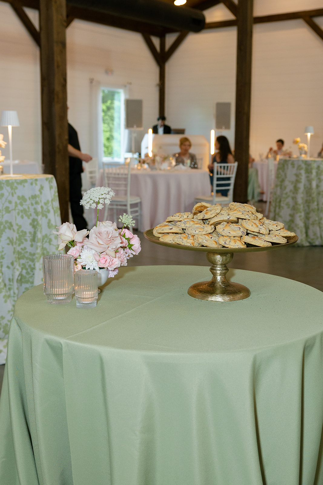 wedding reception table with cookie plate and a pastel floral arrangement
