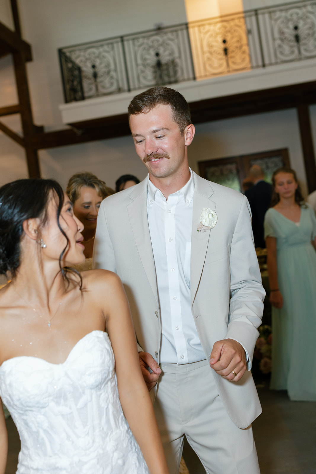 bride looks back at groom as they dance at their South Carolina Wedding reception