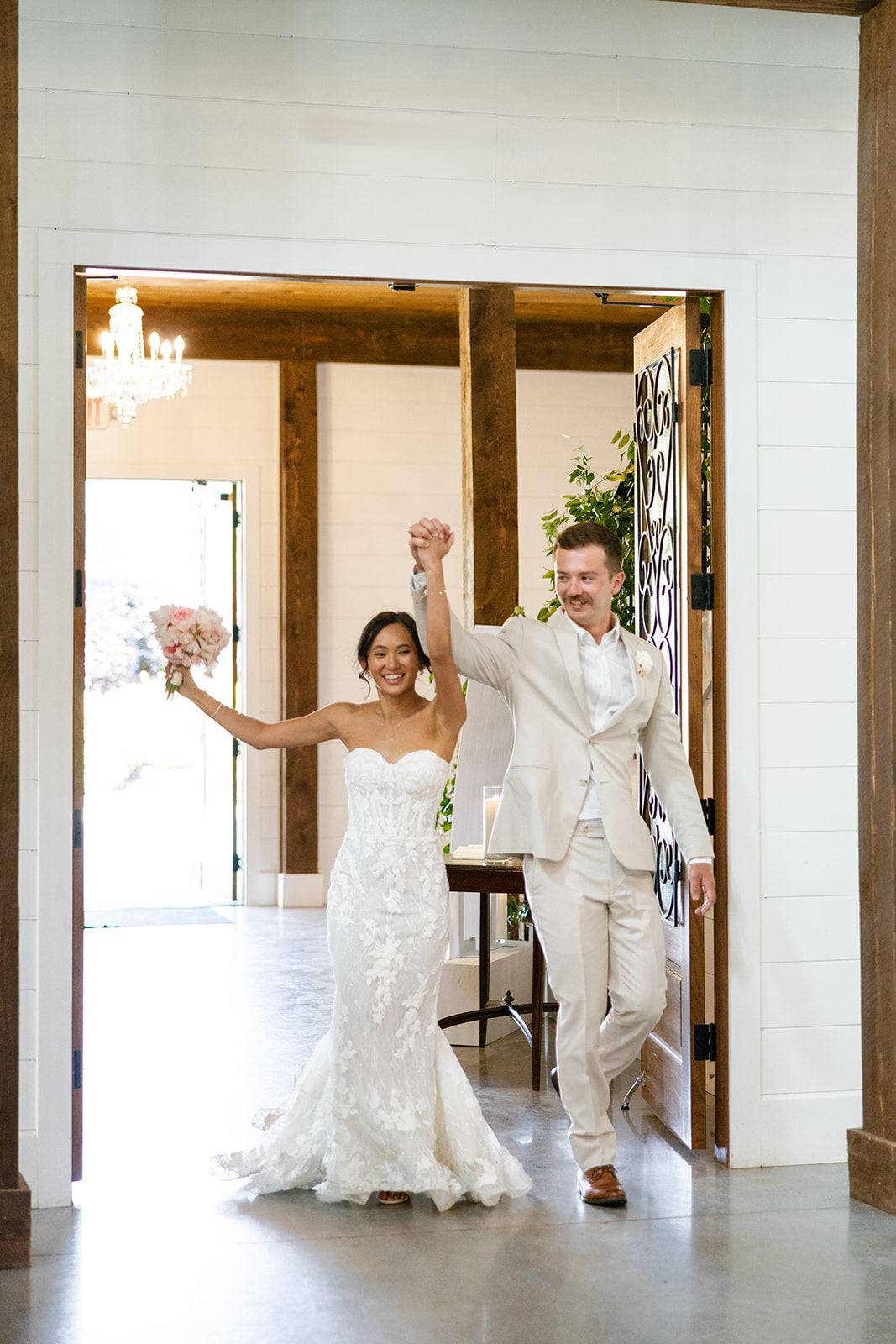 newlyweds joyfully walk into their reception at their South Carolina wedding