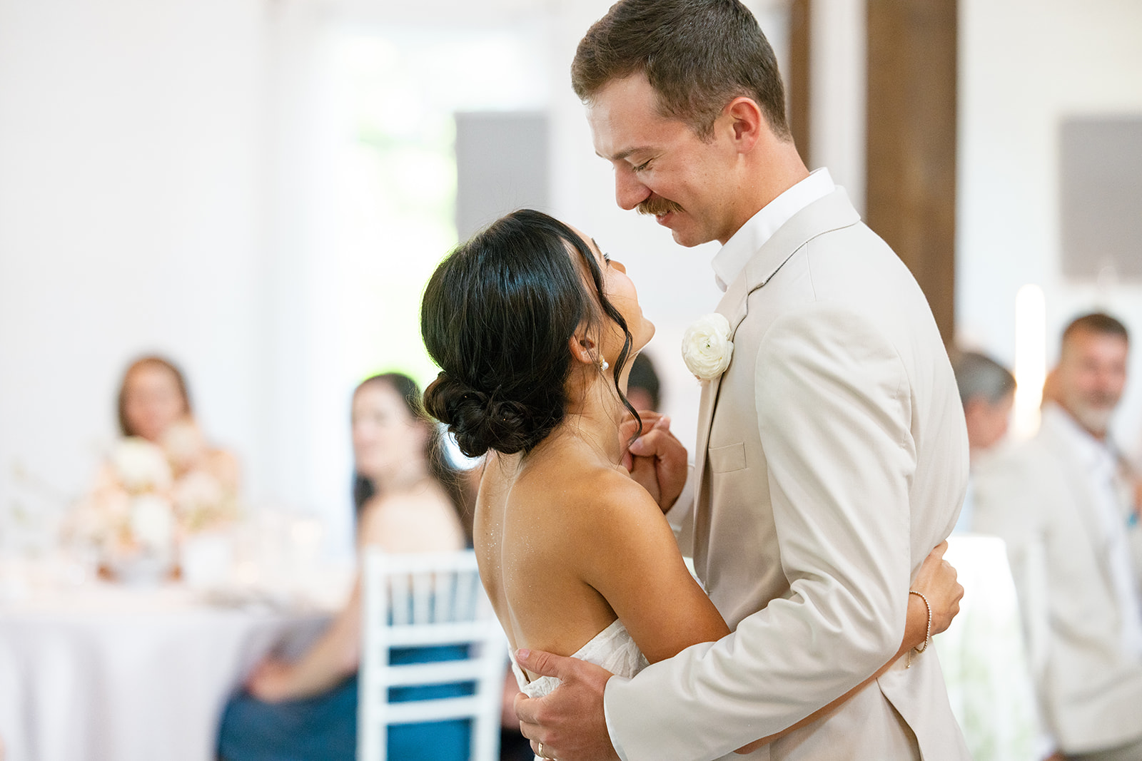 bride grins up at the groom as they share their first dance at The Venue at Edgewood