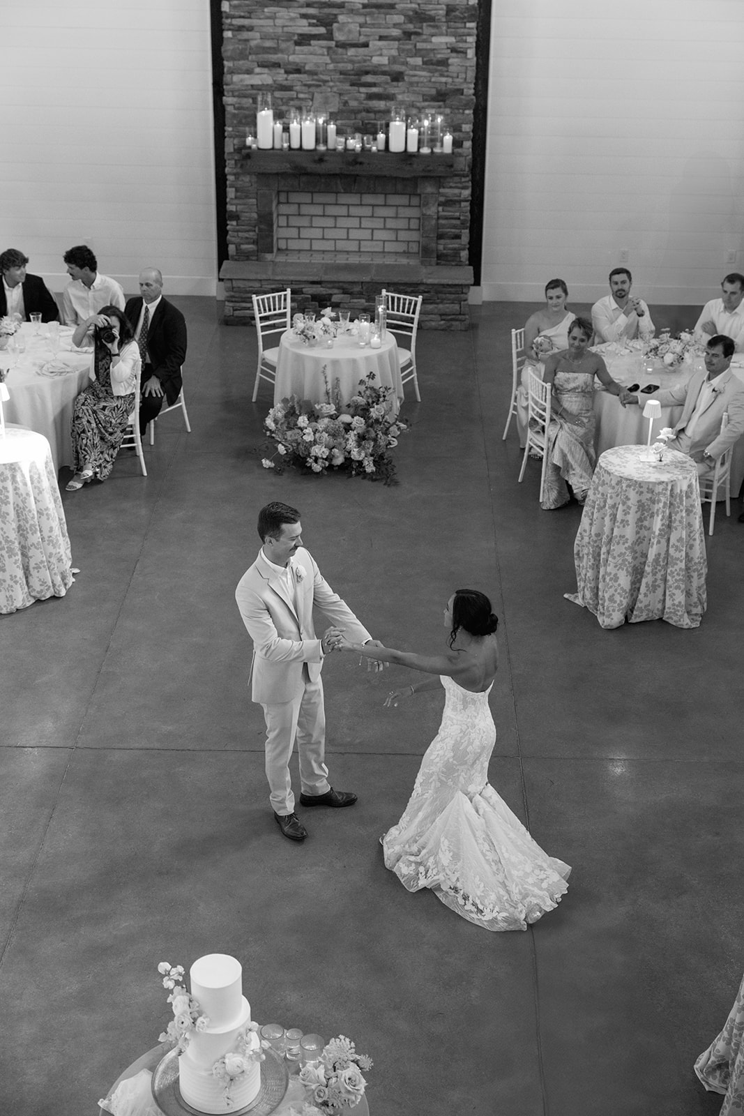 overhead shot of the newlyweds sharing their first dance as friends and family watch