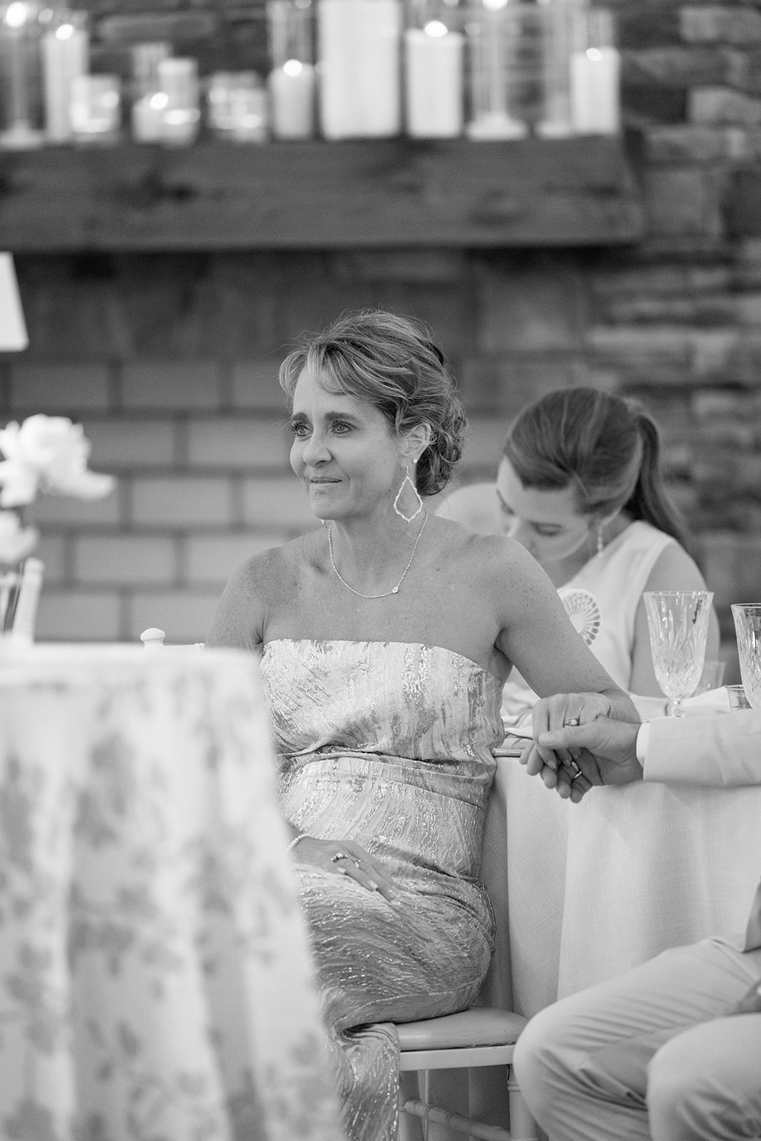 mother of the bride lovingly watches the newlyweds 
