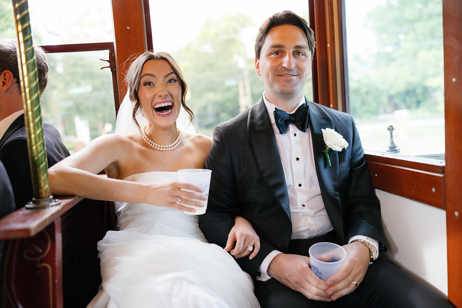 bride and groom on trolley to the wedding venue