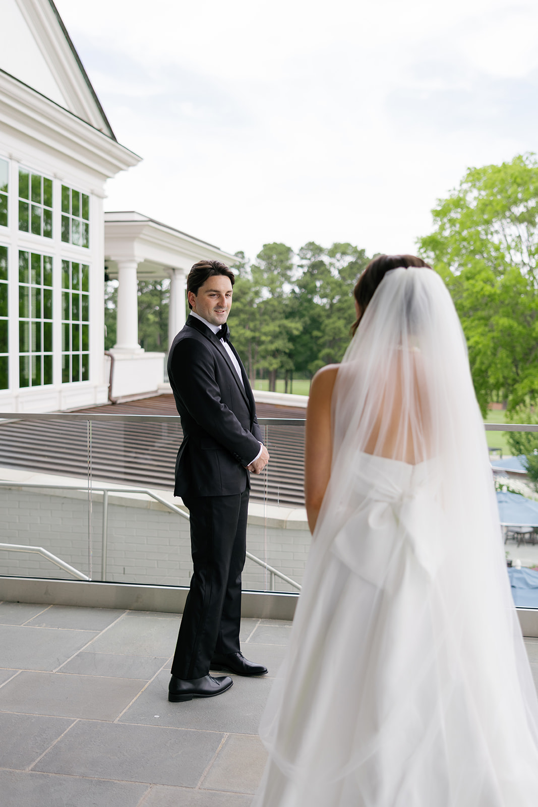 Groom looking emotional as he sees the bride for the first time in her wedding dress.
