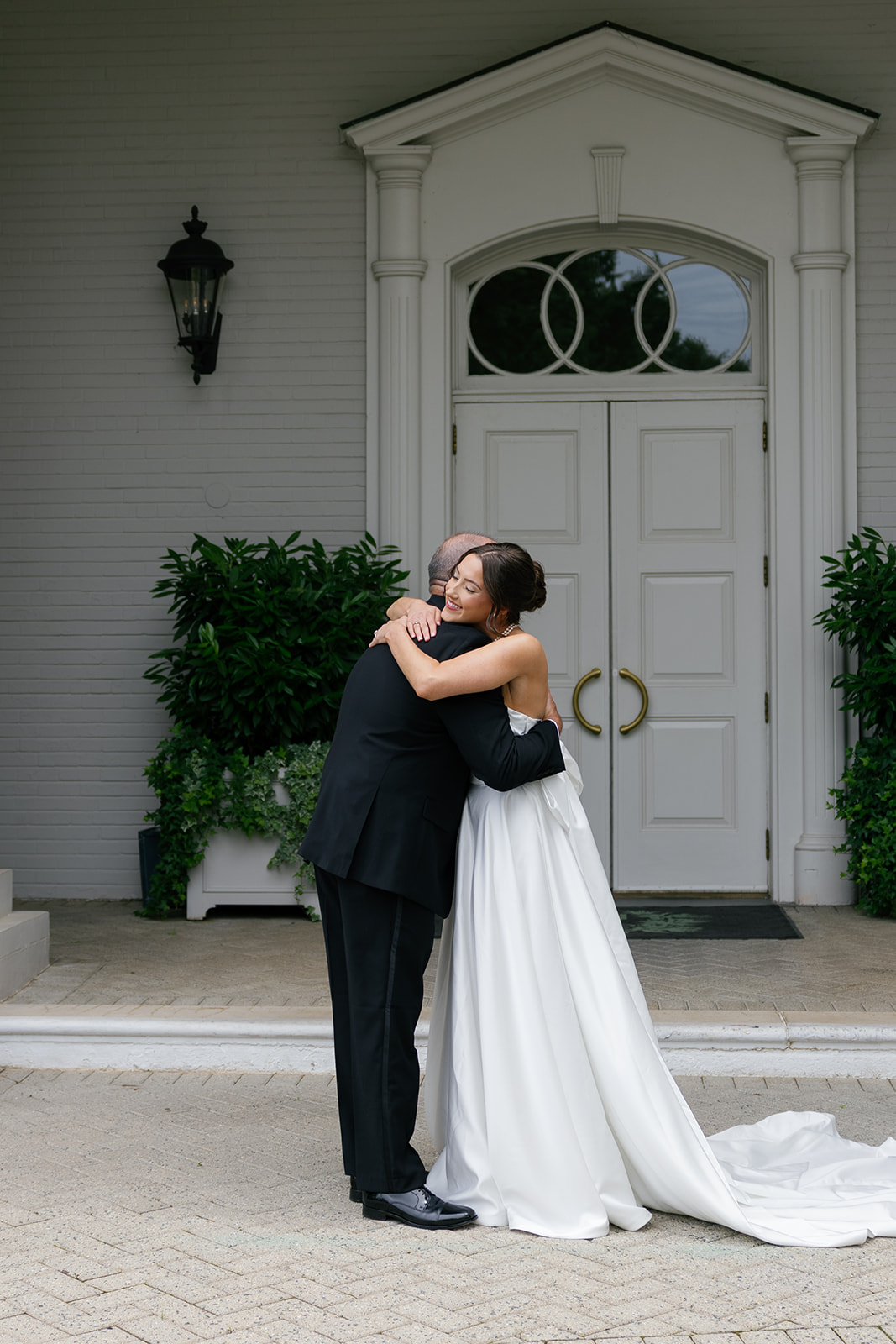 bride hugs her dad during first look with her father