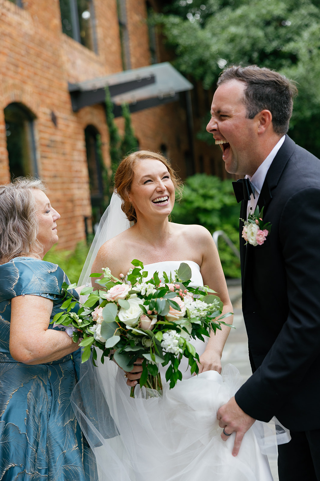 Bride and groom sharing a joyful laugh with family after the ceremony at Huguenot Loft.