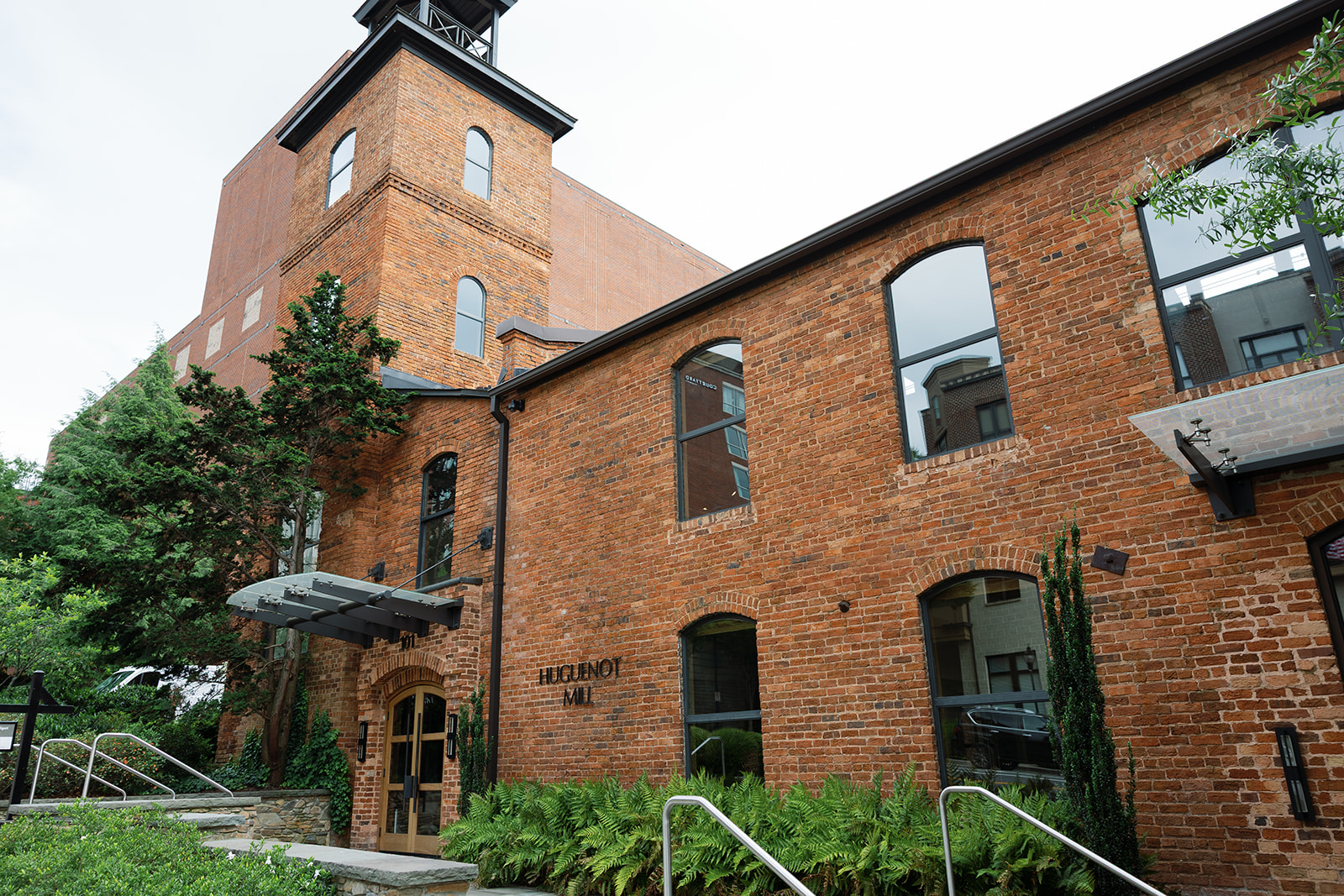 Historic brick exterior of Huguenot Loft and Mill in downtown Greenville, SC, a popular wedding venue with industrial charm and character.