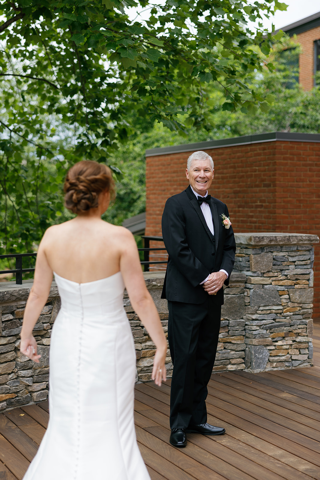 Bride walking toward her dad  for their outdoor first look at Huguenot Loft and Mill.