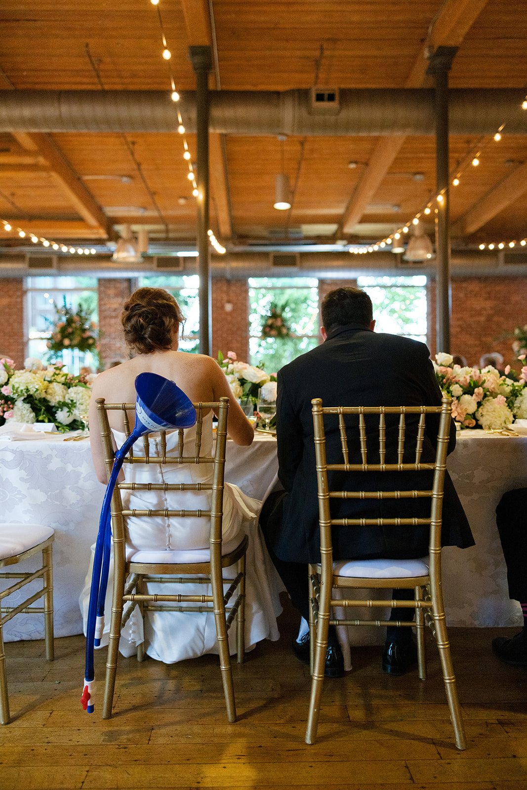 bride and groom at their table eating 