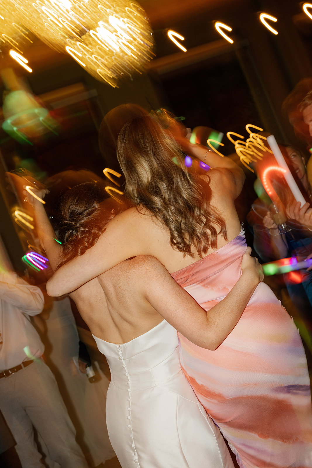 bride hugging a wedding guest on the dance floor