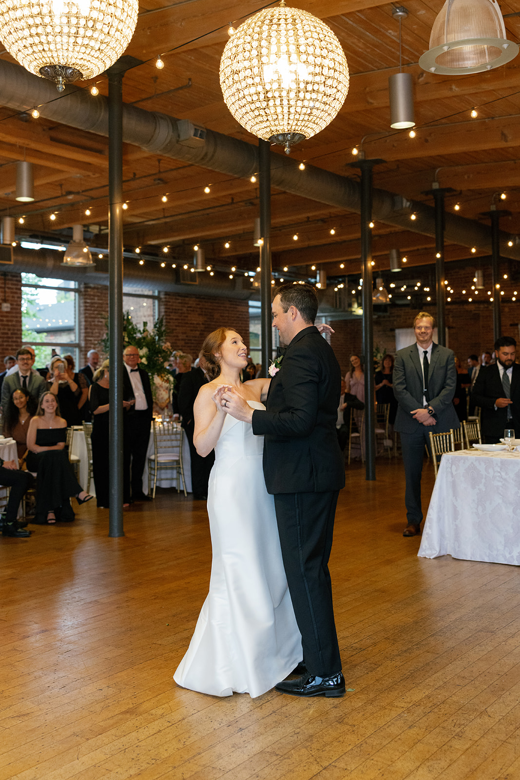 bride and groom sharing a their first dance as guests watch during at SC Wedding Venue