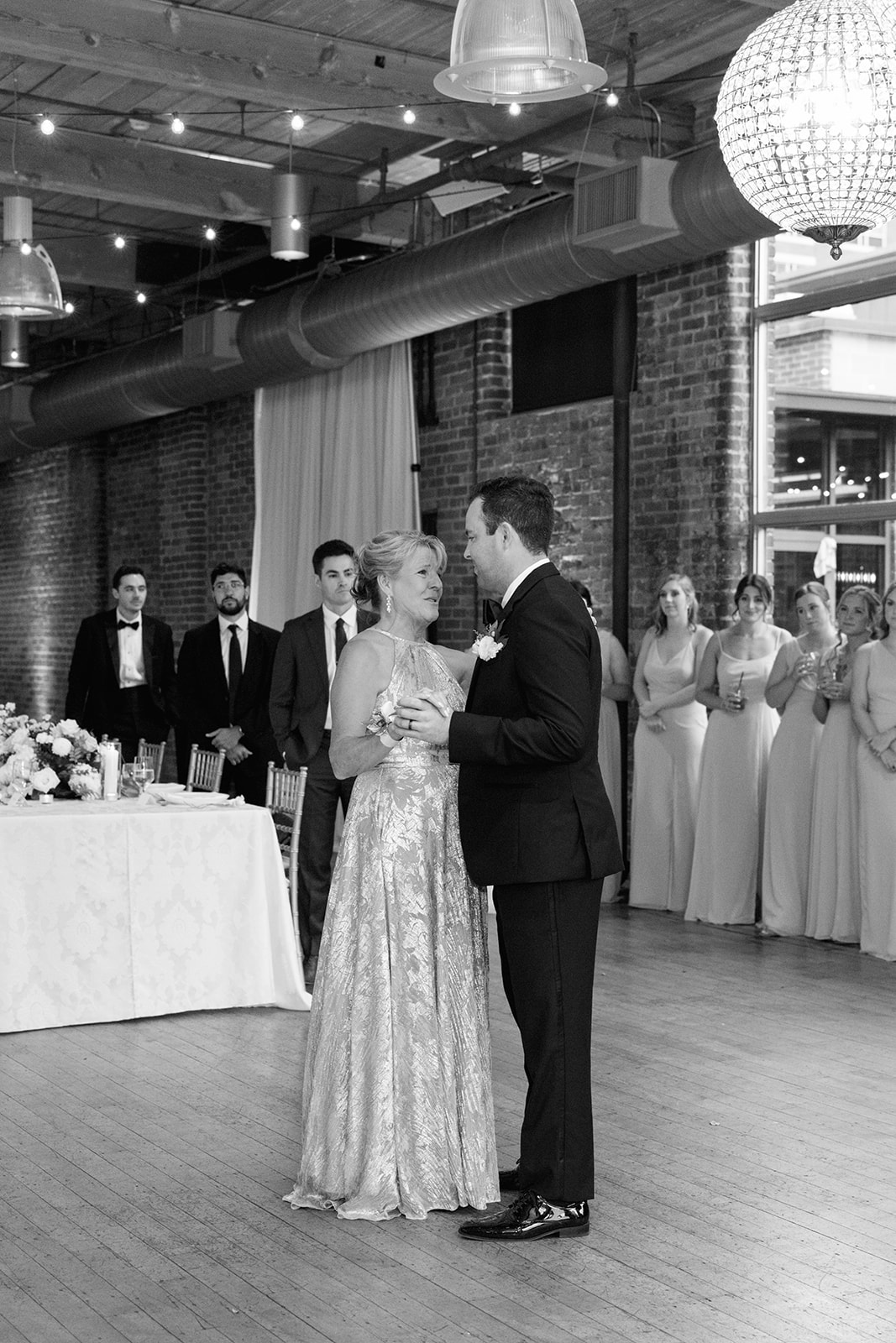 Groom shares a mother-son dance with his mom in a sparkling gown during their Greenville SC wedding reception.