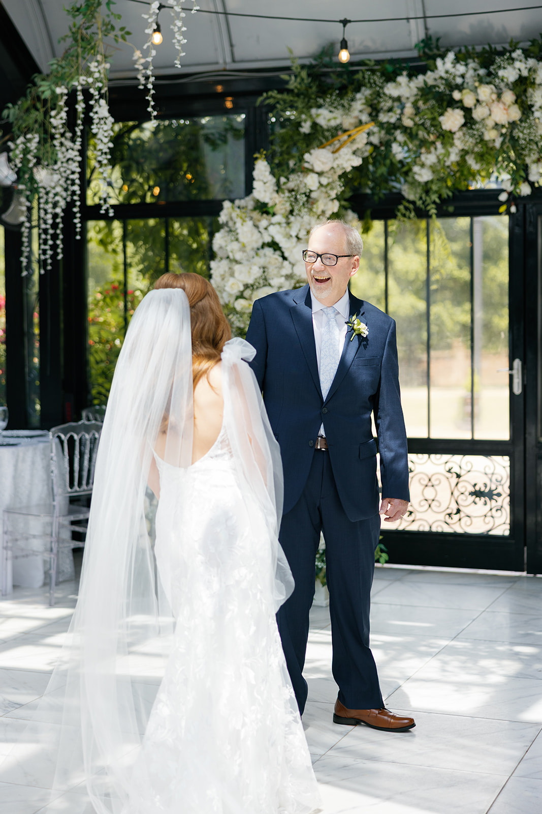 Father of the bride turning to see his daughter for the first time on her wedding day, smiling with joy at Edinburgh West in Greenville, SC.
