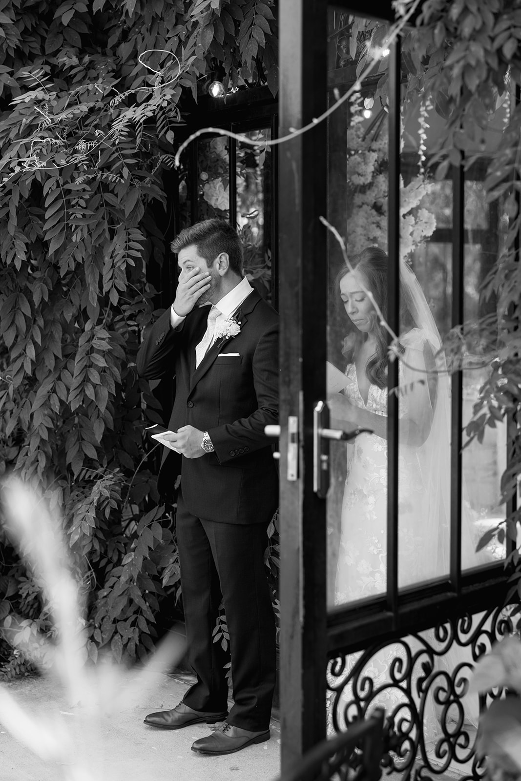 Groom wipes away tears while the bride reads vows during their private first touch at Edinburgh West – emotional candid wedding photography in Greenville.