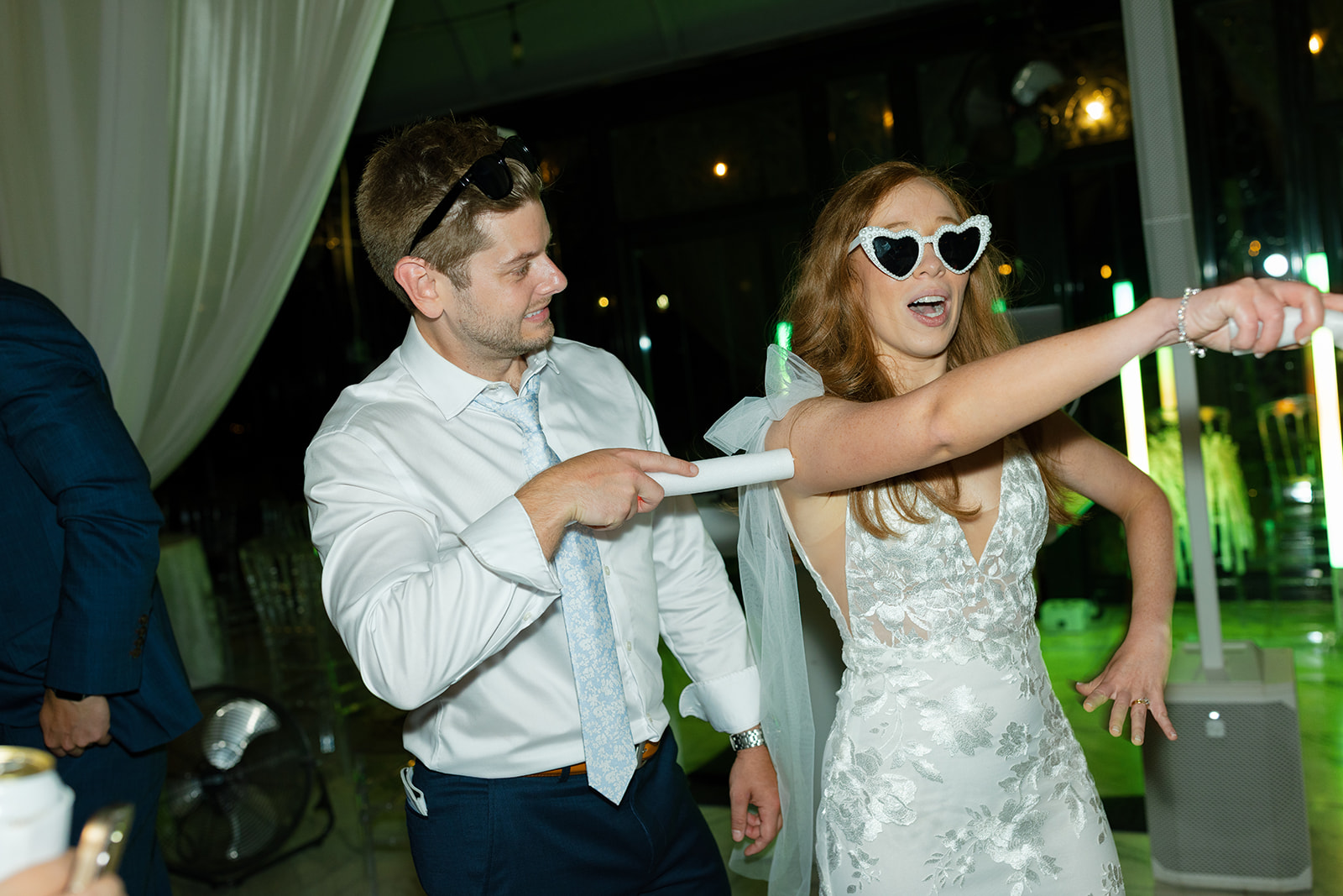 Bride and groom laughing while dancing together, candid wedding photography at Edinburgh West.