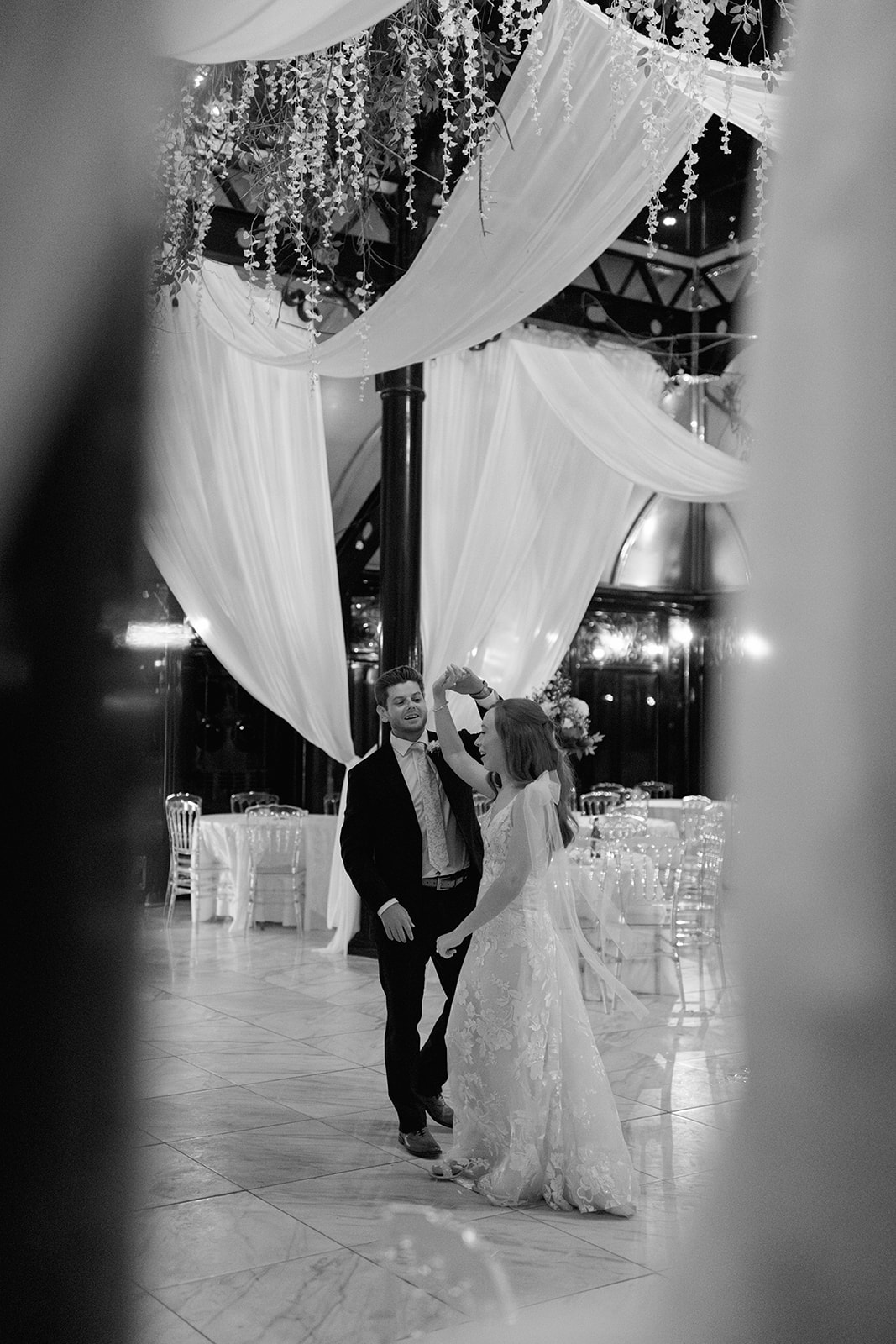Bride and groom laughing while dancing together, candid wedding photography at Edinburgh West.