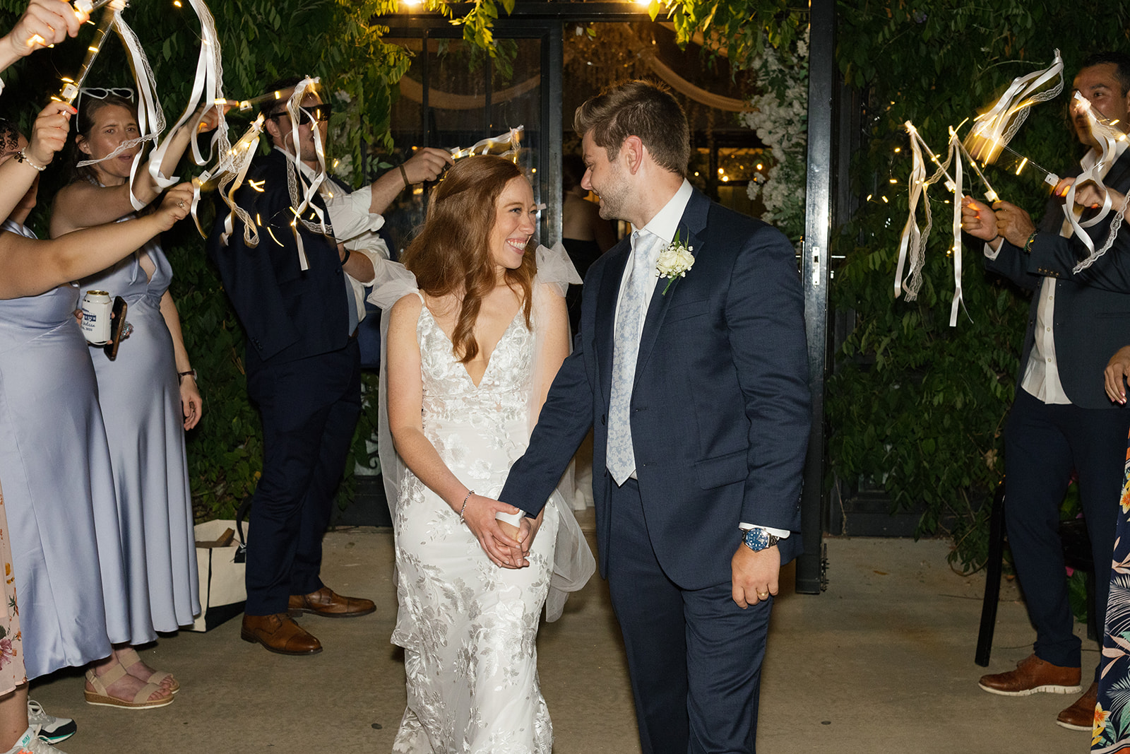 Groom smiling while holding his bride’s hand, candid wedding photography in Greenville, SC.
