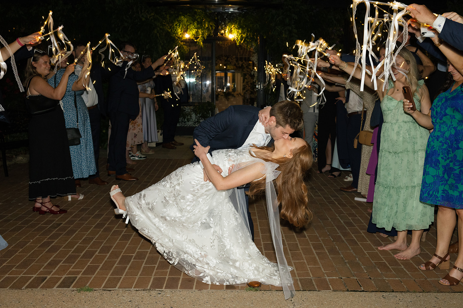 Couple sharing a joyful kiss outside Edinburgh West, posed wedding photos by a Greenville wedding photographer.