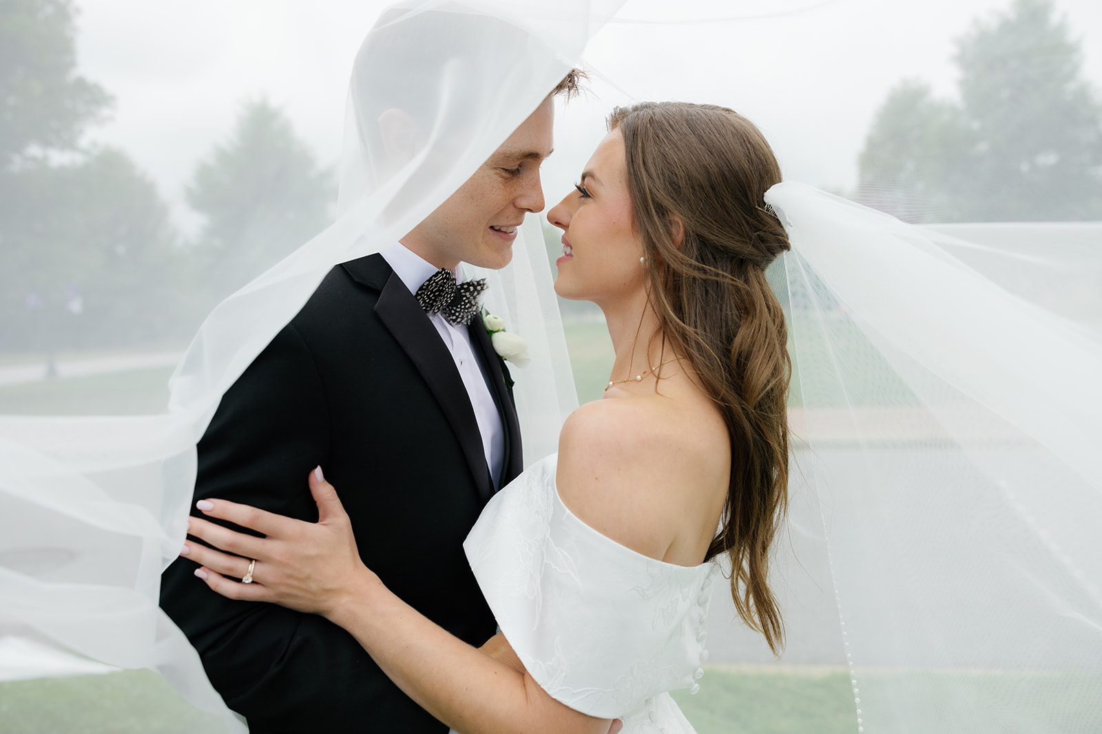 Bride and groom under soft natural light, capturing a heartfelt moment worth prioritizing in your wedding planning timeline.