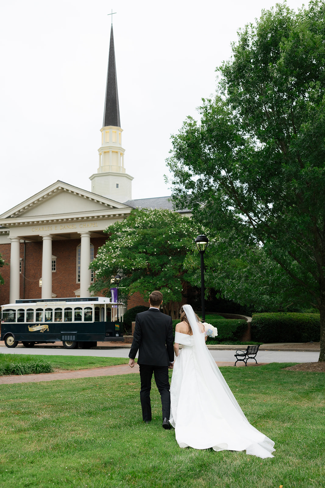 Bride and groom walking towards the Daniel Chapel