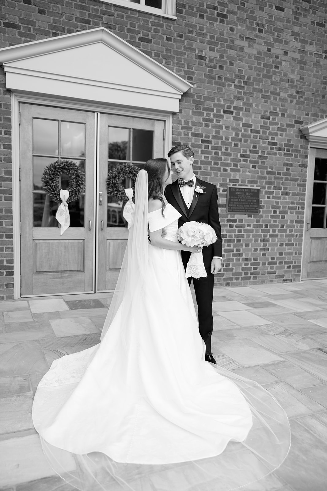 Groom looks lovingly at his bride as they exit the chappel