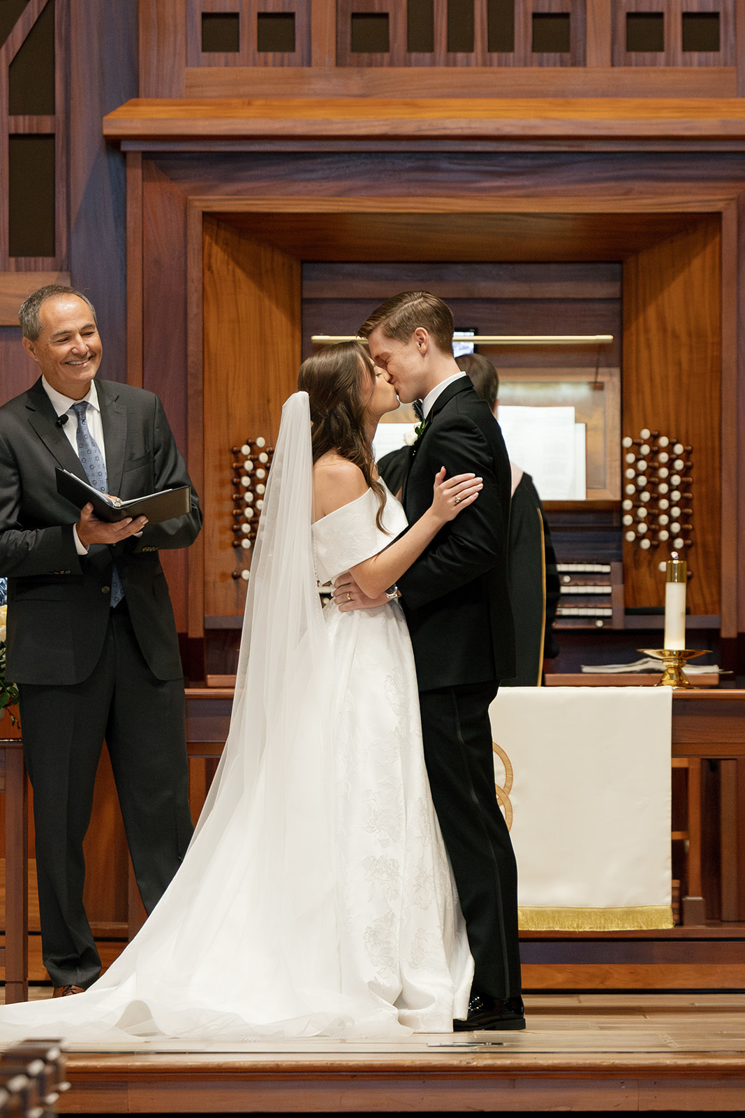 Bride and groom share a kiss during their ceremony at Daniel Chapel at Furman University