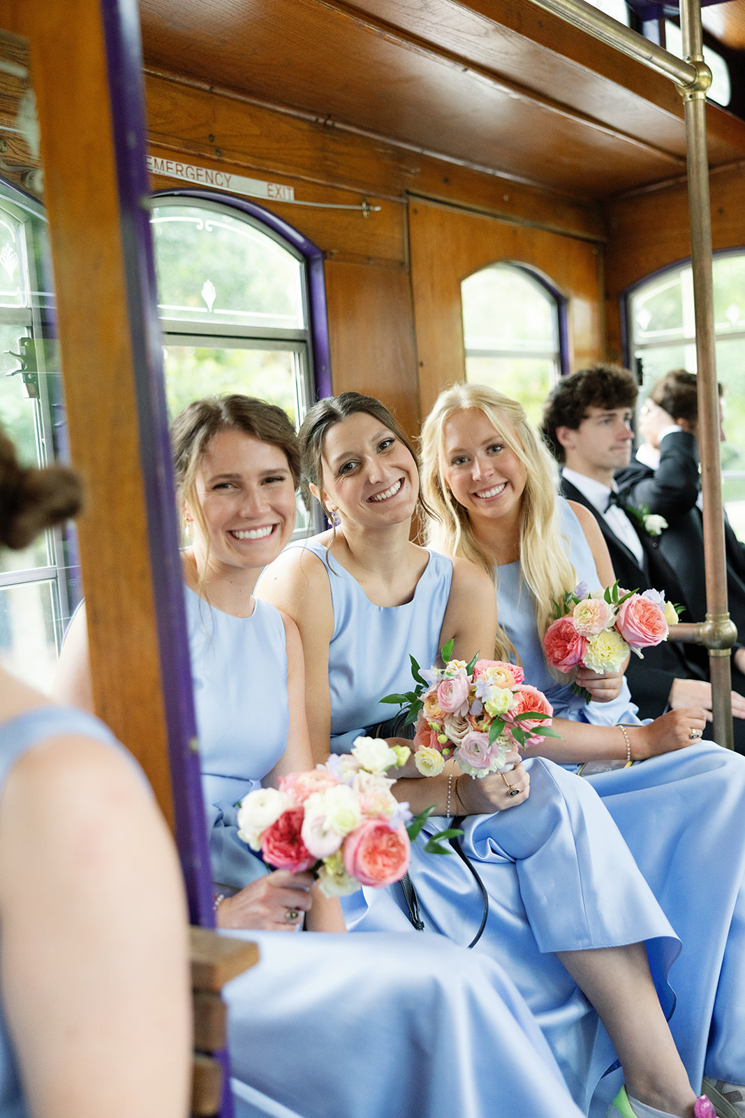 Bridesmaids smile on the trolley in SC