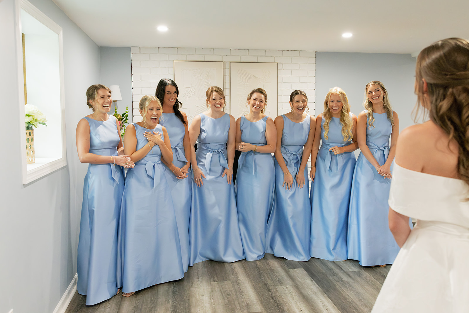 The bride and her bridesmaids share a sweet moment at an Airbnb in Greenville, South Carolina