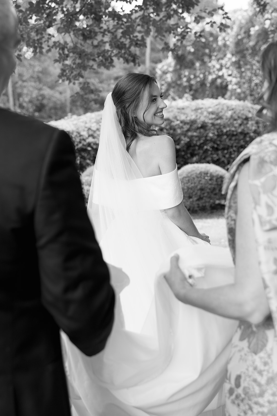 The bride walks with her parents to her Greenville wedding
