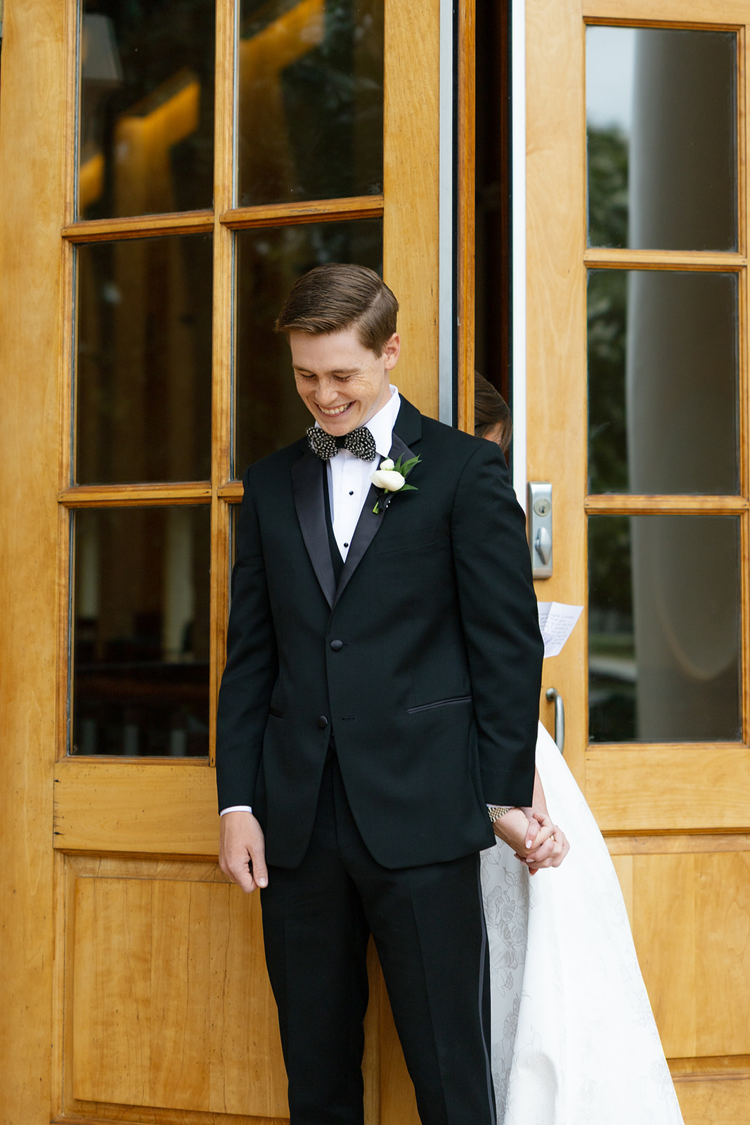 Bride and groom share their first touch on the steps of Daniel Chapel at Furman University