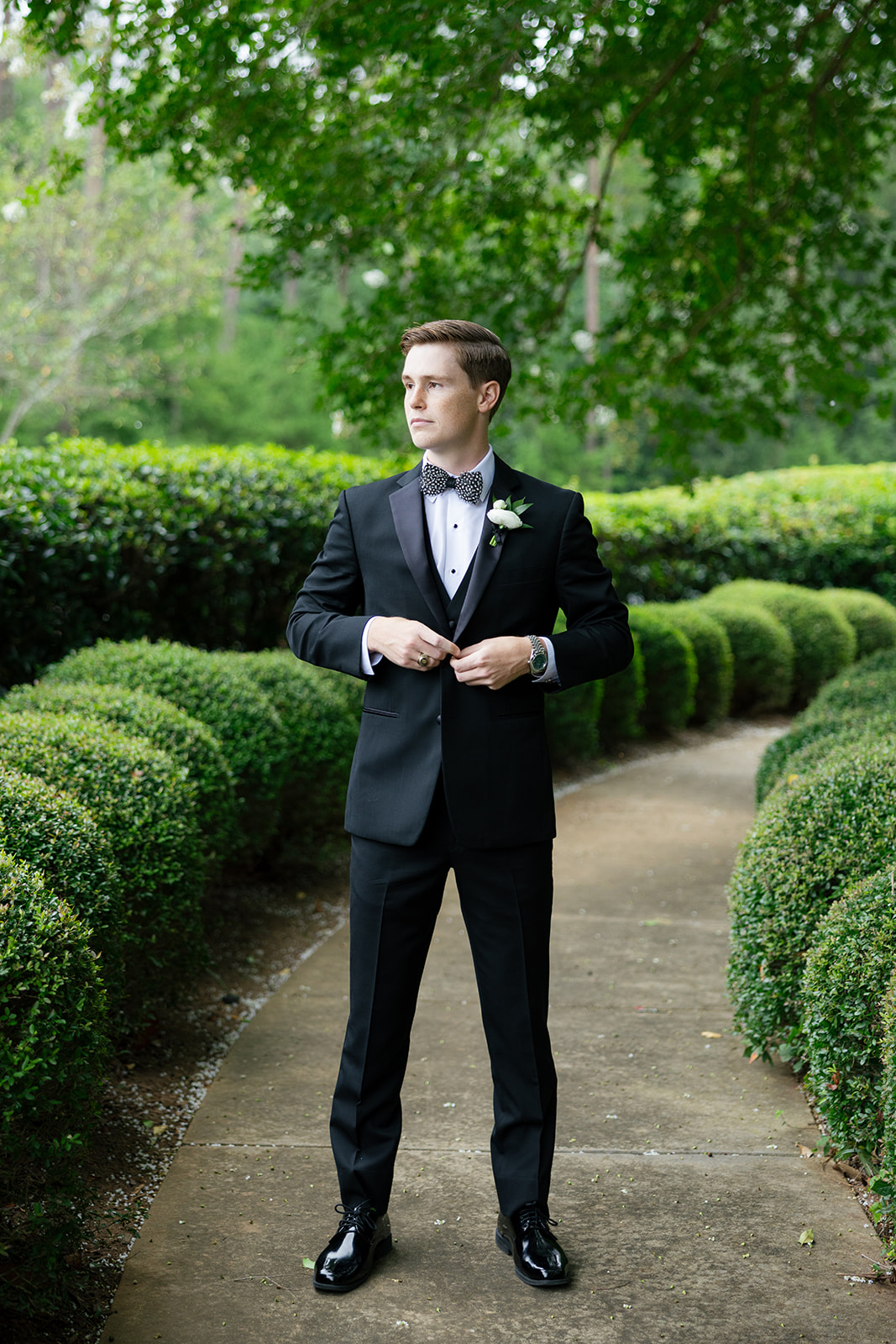 Groom fixes his suit before his South Carolina wedding