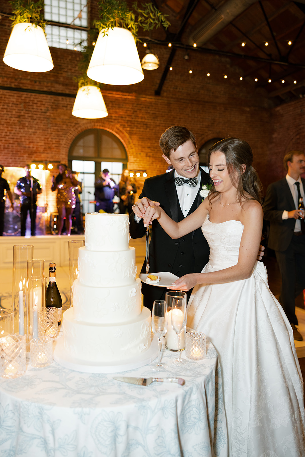 Groom lovingly smiles at bride as they cut their wedding cake