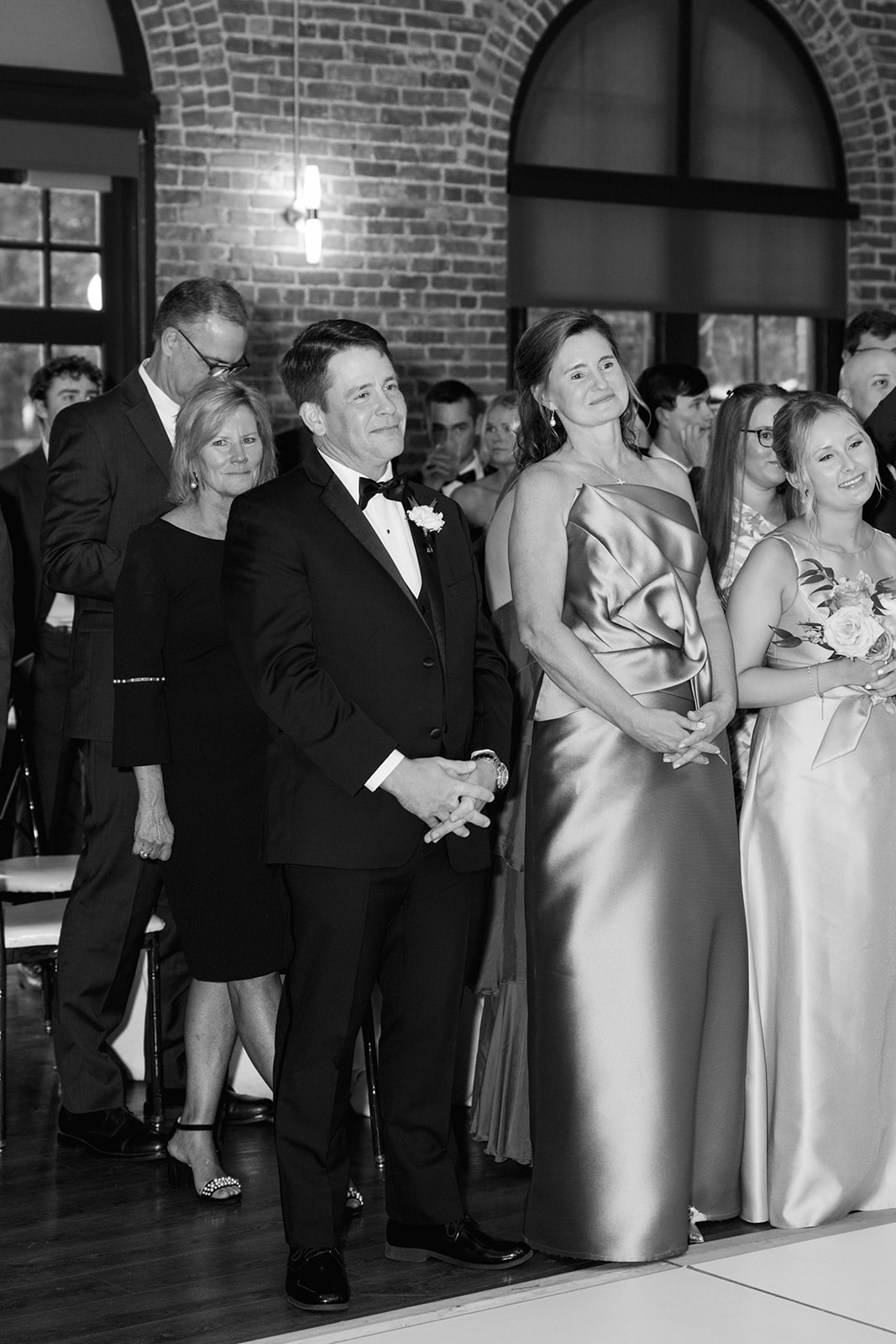 The bride's parents watch as the newlyweds share their first dance