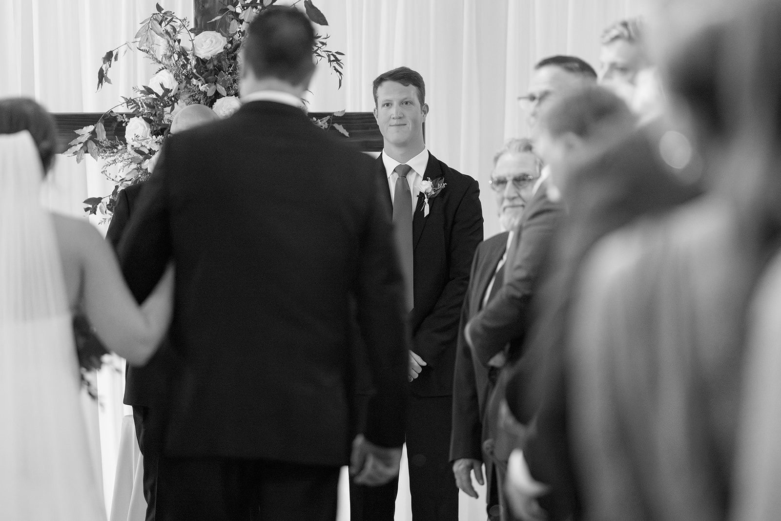 the groom waiting for the bride to walk down the aisle during the ceremony portion of the Wedding Photography Timeline