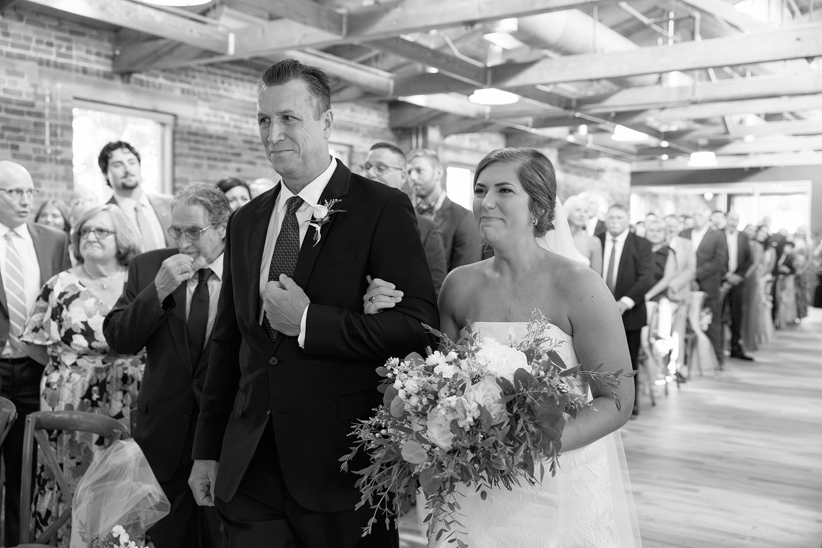 the bride and her dad walking down the aisle together